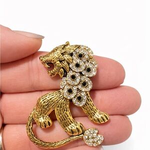Elegant Gold Tone Lion Brooch with Crystals